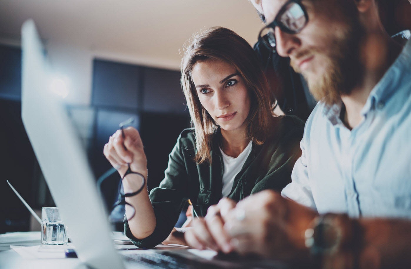 Two professionals reviewing employee benefits options together on a laptop