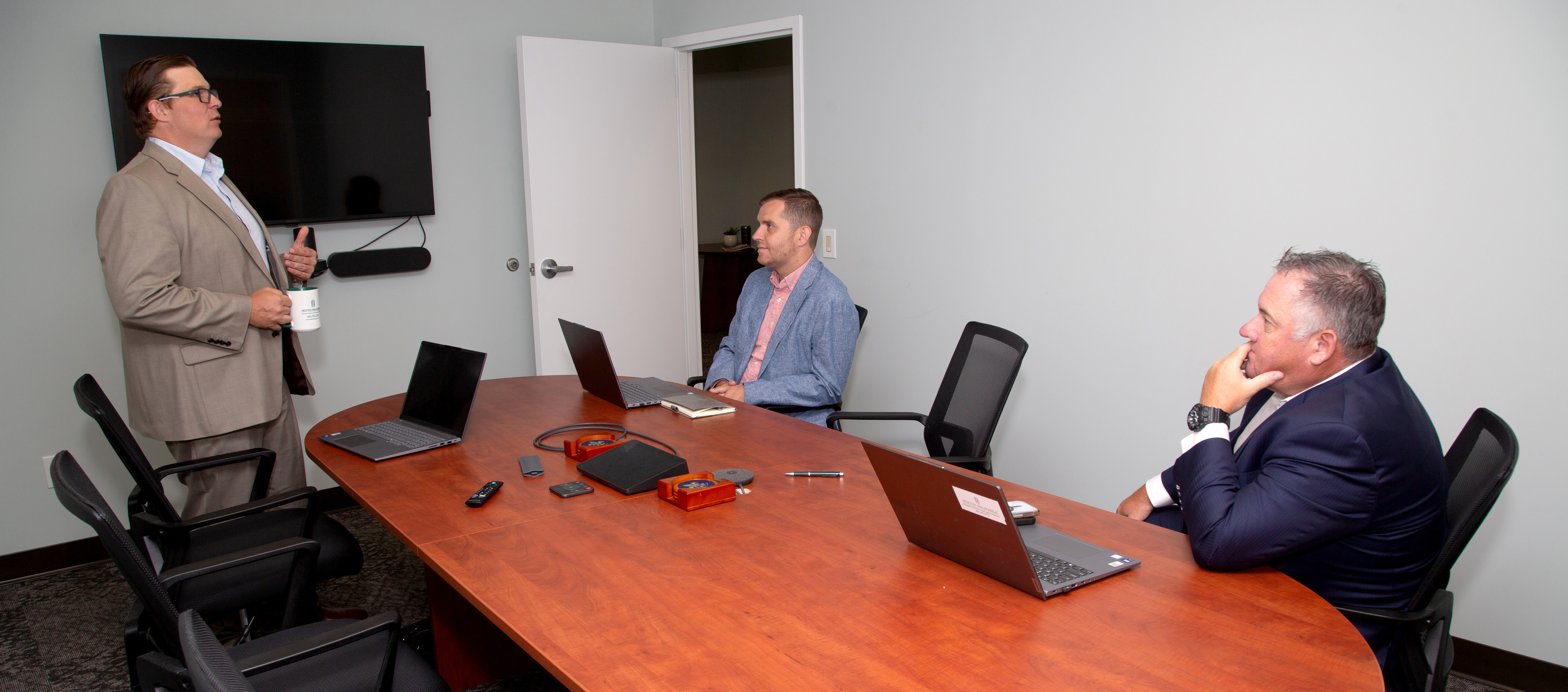 Nester Insurance team members presenting and collaborating in the Collegeville office